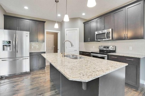 3 Sunset Court, Cochrane, AB - Indoor Photo Showing Kitchen With Upgraded Kitchen