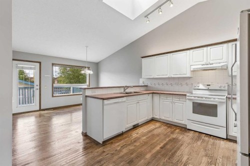 121 Quigley Drive, Cochrane, AB - Indoor Photo Showing Kitchen With Double Sink
