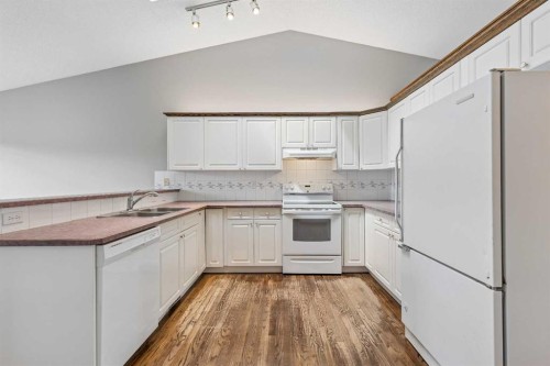 121 Quigley Drive, Cochrane, AB - Indoor Photo Showing Kitchen With Double Sink