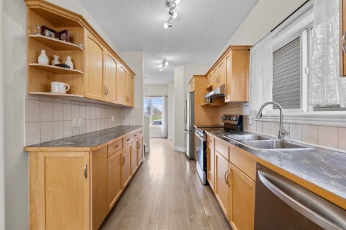 27 Bridleridge View Sw, Calgary, AB - Indoor Photo Showing Kitchen With Double Sink