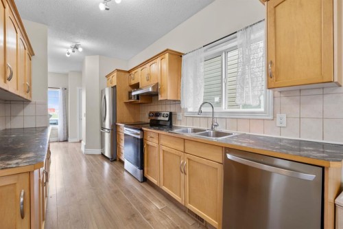 27 Bridleridge View Sw, Calgary, AB - Indoor Photo Showing Kitchen With Double Sink