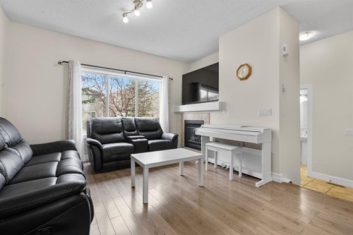 27 Bridleridge View Sw, Calgary, AB - Indoor Photo Showing Living Room With Fireplace