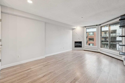 304-317 19 Avenue Sw, Calgary, AB - Indoor Photo Showing Living Room With Fireplace