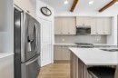 7 Emberside Park, Cochrane, AB  - Indoor Photo Showing Kitchen With Upgraded Kitchen 
