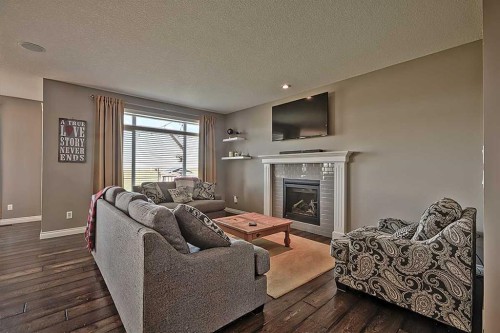 732 Hampton Hills Drive Ne, High River, AB - Indoor Photo Showing Living Room With Fireplace