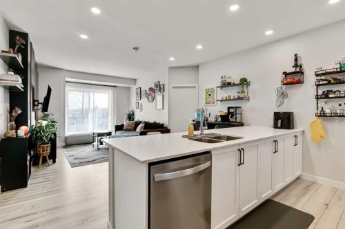 208-255 Les Jardins Park Se, Calgary, AB - Indoor Photo Showing Kitchen With Double Sink