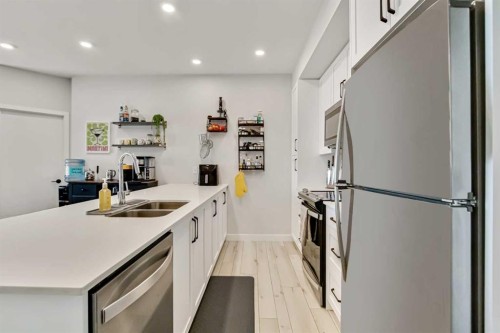 208-255 Les Jardins Park Se, Calgary, AB - Indoor Photo Showing Kitchen With Stainless Steel Kitchen With Double Sink