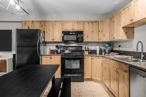 111-300 Palliser, Canmore, AB - Indoor Photo Showing Kitchen With Double Sink