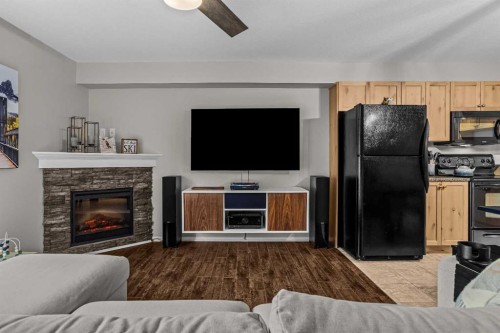 111-300 Palliser, Canmore, AB - Indoor Photo Showing Living Room With Fireplace