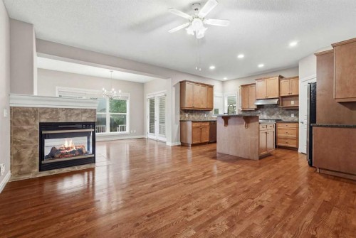 378 Chaparral Ridge Circle Se, Calgary, AB - Indoor Photo Showing Kitchen With Fireplace
