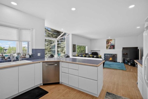 523 Scimitar Bay Nw, Calgary, AB - Indoor Photo Showing Kitchen With Fireplace