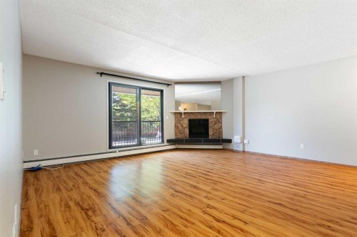 3101-4001C 49 Street Nw, Calgary, AB - Indoor Photo Showing Living Room With Fireplace