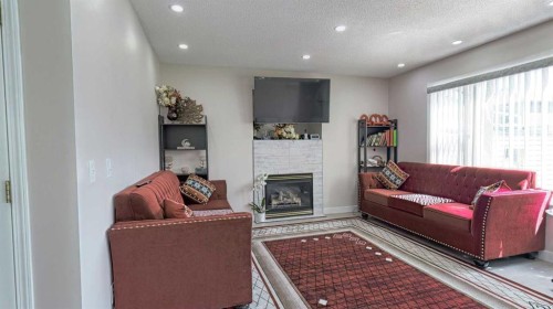 54 Saddlecreek Crescent Ne, Calgary, AB - Indoor Photo Showing Living Room With Fireplace