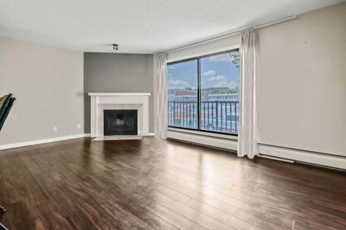 204-1512 16 Avenue Sw, Calgary, AB - Indoor Photo Showing Living Room With Fireplace