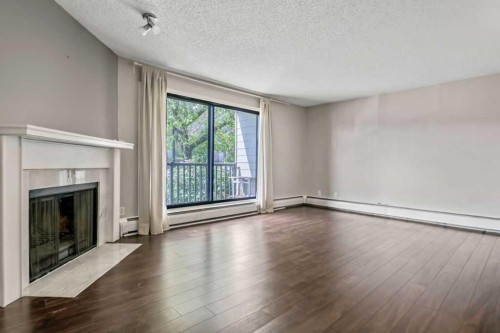 204-1512 16 Avenue Sw, Calgary, AB - Indoor Photo Showing Other Room With Fireplace