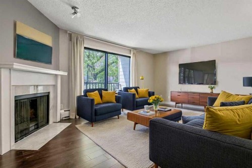 204-1512 16 Avenue Sw, Calgary, AB - Indoor Photo Showing Living Room With Fireplace