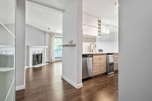 204-1512 16 Avenue Sw, Calgary, AB - Indoor Photo Showing Kitchen With Fireplace