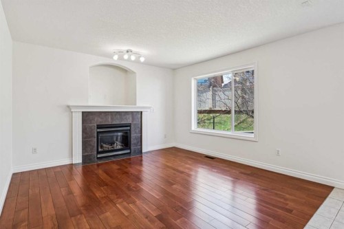 22 Sherwood Cove Nw, Calgary, AB - Indoor Photo Showing Living Room With Fireplace