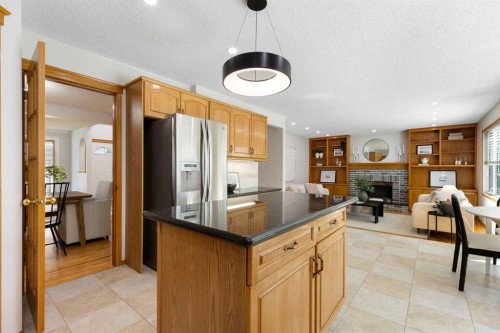 136 Schubert Hill Nw, Calgary, AB - Indoor Photo Showing Kitchen With Fireplace