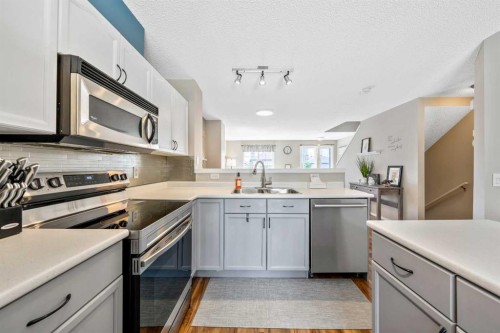 43 Toscana Gardens Nw, Calgary, AB - Indoor Photo Showing Kitchen With Stainless Steel Kitchen With Double Sink