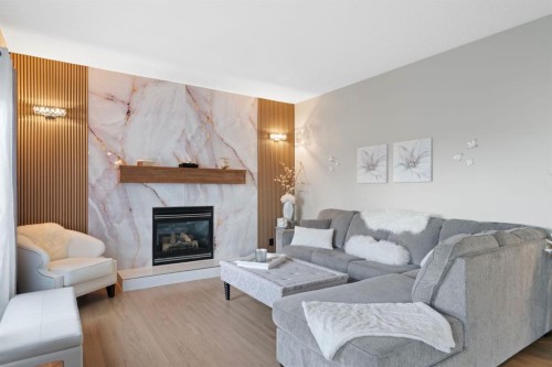 16 Bow Ridge Drive, Cochrane, AB - Indoor Photo Showing Living Room With Fireplace