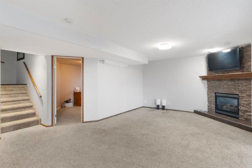 16 Bow Ridge Drive, Cochrane, AB - Indoor With Fireplace