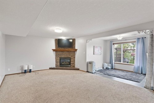16 Bow Ridge Drive, Cochrane, AB - Indoor Photo Showing Other Room With Fireplace