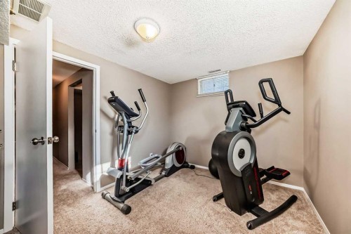 85 Rideau Close Sw, Airdrie, AB - Indoor Photo Showing Gym Room