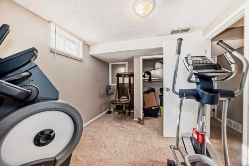 85 Rideau Close Sw, Airdrie, AB - Indoor Photo Showing Gym Room