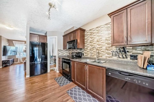 173 Eversyde Common Sw, Calgary, AB - Indoor Photo Showing Kitchen With Double Sink