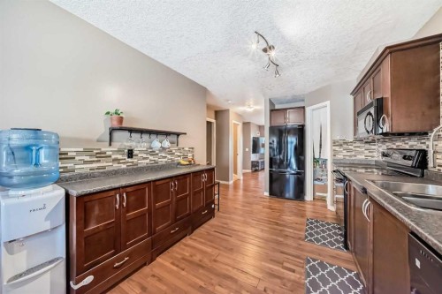173 Eversyde Common Sw, Calgary, AB - Indoor Photo Showing Kitchen With Double Sink