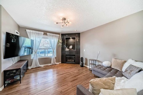 173 Eversyde Common Sw, Calgary, AB - Indoor Photo Showing Living Room With Fireplace