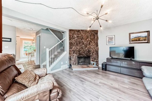 6739 Coach Hill Road Sw, Calgary, AB - Indoor Photo Showing Living Room With Fireplace