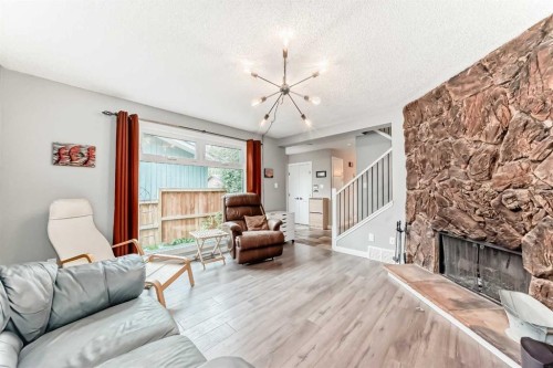 6739 Coach Hill Road Sw, Calgary, AB - Indoor Photo Showing Living Room With Fireplace