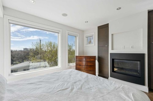 911 Drury Avenue Ne, Calgary, AB - Indoor Photo Showing Bedroom With Fireplace