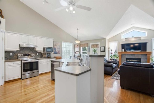 69 Chaparral Villas Se, Calgary, AB - Indoor Photo Showing Kitchen With Fireplace With Double Sink