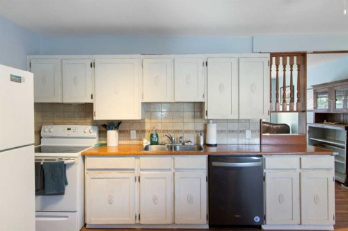 1622 Strathcona Street, Crossfield, AB - Indoor Photo Showing Kitchen With Double Sink