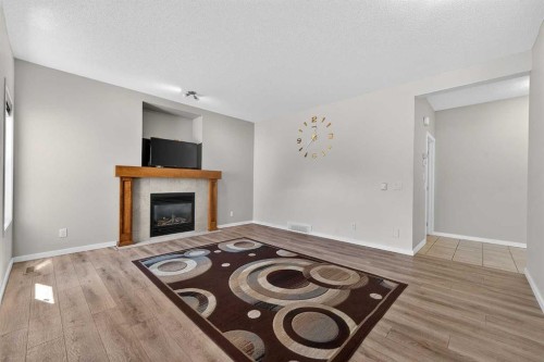 52 Reunion Close Nw, Airdrie, AB - Indoor Photo Showing Other Room With Fireplace