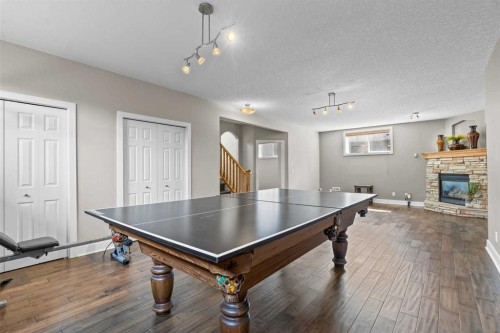 25 Panamount Green Nw, Calgary, AB - Indoor Photo Showing Other Room With Fireplace
