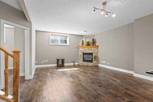 25 Panamount Green Nw, Calgary, AB - Indoor Photo Showing Living Room With Fireplace