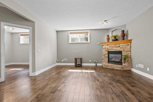 25 Panamount Green Nw, Calgary, AB - Indoor Photo Showing Living Room With Fireplace