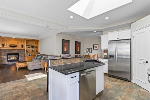 25 Panamount Green Nw, Calgary, AB - Indoor Photo Showing Kitchen With Fireplace