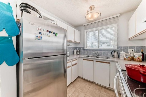 144-7172 Coach Hill Road Sw, Calgary, AB - Indoor Photo Showing Kitchen With Double Sink