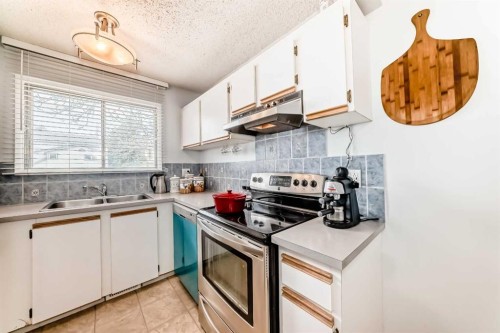 144-7172 Coach Hill Road Sw, Calgary, AB - Indoor Photo Showing Kitchen With Stainless Steel Kitchen With Double Sink