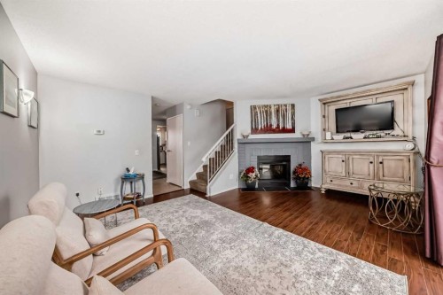 144-7172 Coach Hill Road Sw, Calgary, AB - Indoor Photo Showing Living Room With Fireplace