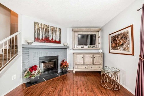 144-7172 Coach Hill Road Sw, Calgary, AB - Indoor Photo Showing Living Room With Fireplace