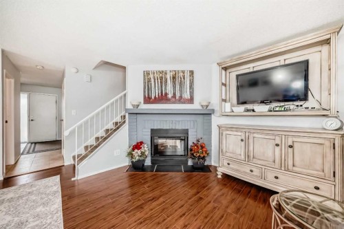 144-7172 Coach Hill Road Sw, Calgary, AB - Indoor Photo Showing Living Room With Fireplace