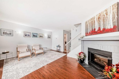 144-7172 Coach Hill Road Sw, Calgary, AB - Indoor Photo Showing Living Room With Fireplace