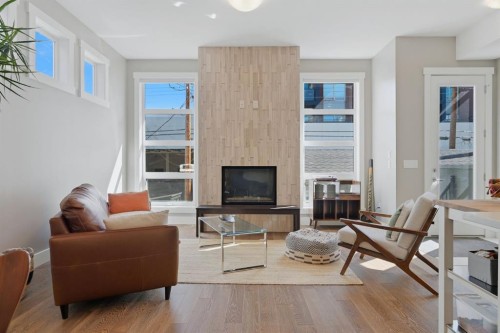 2-4620 17 Avenue Nw, Calgary, AB - Indoor Photo Showing Living Room With Fireplace