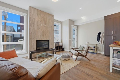2-4620 17 Avenue Nw, Calgary, AB - Indoor Photo Showing Living Room With Fireplace